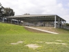Steel building over school sports court, with round safety posts - Melbourne, VIC