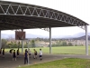 Curved roof steel building over school sports court, with round safety posts - Melbourne Victoria